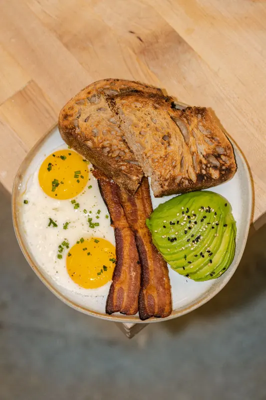 Breakfast plate with eggs, bacon, and toasted sourdough